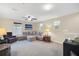 Upstairs loft with a cozy seating area, ceiling fan, and natural light at 11579 Acosta Ave, Orlando, FL 32836