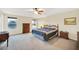 Spacious main bedroom with carpet, a fan, large windows and lake views at 11579 Acosta Ave, Orlando, FL 32836