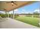 Covered patio overlooking a serene lake, perfect for outdoor relaxation and entertaining at 11579 Acosta Ave, Orlando, FL 32836