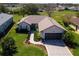 Picture of property featuring manicured lawn, expansive driveway, and a charming facade at 12199 Se 175Th Loop, Summerfield, FL 34491
