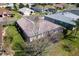 Rear of home featuring neat lawn, screened patio, and treed area at 12199 Se 175Th Loop, Summerfield, FL 34491