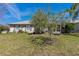 A well-manicured lawn and mature trees offer a tranquil setting for this lovely home at 12199 Se 175Th Loop, Summerfield, FL 34491