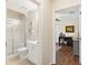 Well-lit bathroom with a glass-enclosed shower and adjacent home office space at 12199 Se 175Th Loop, Summerfield, FL 34491