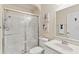 Clean bathroom featuring a glass-enclosed shower, modern fixtures, and decorative wall art at 12199 Se 175Th Loop, Summerfield, FL 34491