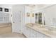 A bright bathroom with double vanity, large mirror, soaking tub, and walk-in shower at 12199 Se 175Th Loop, Summerfield, FL 34491