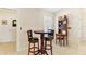Cozy breakfast nook with a dark wood table and chairs, adjacent to a hutch and a window with shutters at 12199 Se 175Th Loop, Summerfield, FL 34491