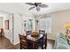 Cozy dining room features a vaulted ceiling with fan, wood floors, and access to the lanai at 12199 Se 175Th Loop, Summerfield, FL 34491