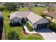 Inviting single-story home with a well-manicured lawn, mature landscaping, and a two-car garage at 12199 Se 175Th Loop, Summerfield, FL 34491
