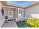 Close up of front door showcasing a welcoming entrance and tidy landscaping at 12199 Se 175Th Loop, Summerfield, FL 34491