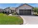 Charming single-story home with lush lawn, neat landscaping, and a two-car garage at 12199 Se 175Th Loop, Summerfield, FL 34491