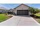 Charming home featuring a two-car garage, decorative driveway, and lush landscaping at 12199 Se 175Th Loop, Summerfield, FL 34491