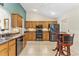 Well-equipped kitchen with stainless steel appliances, wooden cabinetry, and tiled backsplash at 12199 Se 175Th Loop, Summerfield, FL 34491