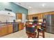 Spacious kitchen with stainless appliances, breakfast bar with seating and convenient access to the living area at 12199 Se 175Th Loop, Summerfield, FL 34491