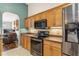 Charming kitchen features wooden cabinets, stainless steel appliances and a seamless transition into the living area at 12199 Se 175Th Loop, Summerfield, FL 34491