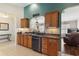 Bright kitchen featuring stainless steel appliances, wooden cabinets, and an open layout with an eat-in bar area at 12199 Se 175Th Loop, Summerfield, FL 34491