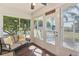 Enclosed lanai with cozy seating offering a relaxing space to enjoy the backyard views at 12199 Se 175Th Loop, Summerfield, FL 34491