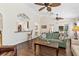 Spacious living room with an open layout to the kitchen, ceiling fans, and access to the outdoors at 12199 Se 175Th Loop, Summerfield, FL 34491