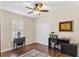 Bright home office with hardwood floors, a ceiling fan, and ample desk space at 12199 Se 175Th Loop, Summerfield, FL 34491