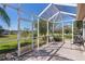 Spacious screened-in patio with outdoor seating and views of the well-maintained lawn and landscaping at 12199 Se 175Th Loop, Summerfield, FL 34491