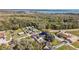 Aerial view of the property surrounded by trees and close to a beautiful lake at 1301 N Shore Dr, Leesburg, FL 34748