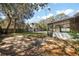 Spacious backyard with a mix of brick and concrete, leads to a screened-in patio at 1301 N Shore Dr, Leesburg, FL 34748