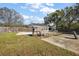 Generous backyard area with basketball court, partially fenced pool, and storage shed at 1301 N Shore Dr, Leesburg, FL 34748