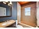 Bathroom features tub and shower combination, stylish vanity and mirror with ample light at 1301 N Shore Dr, Leesburg, FL 34748