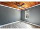 Bedroom with painted walls, wood-look floors, ceiling fan, and window providing natural light at 1301 N Shore Dr, Leesburg, FL 34748