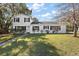 Two-story home with well-manicured lawn and walkway on a sunny day at 1301 N Shore Dr, Leesburg, FL 34748