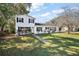 Two-story home with well-manicured lawn and mature trees on a sunny day at 1301 N Shore Dr, Leesburg, FL 34748