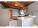 Kitchen featuring tile floors, gray walls, wood cabinets, and stainless steel appliances at 1301 N Shore Dr, Leesburg, FL 34748