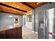 Spacious kitchen with breakfast bar, stainless steel fridge and views into other rooms at 1301 N Shore Dr, Leesburg, FL 34748
