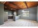Spacious kitchen features a wood plank ceiling, tile flooring, and a view from the window at 1301 N Shore Dr, Leesburg, FL 34748