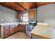 Kitchen featuring tile floors, gray walls, wood cabinets, and stainless steel oven at 1301 N Shore Dr, Leesburg, FL 34748