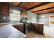 Kitchen with wood cabinets, stainless steel appliances, breakfast bar and tile floor at 1301 N Shore Dr, Leesburg, FL 34748