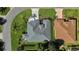 Aerial view shows the home's roof and backyard with lush landscaping and privacy hedges at 1367 Honea Path, The Villages, FL 32162