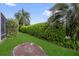The beautifully landscaped backyard features a well-maintained lawn and mature trees at 1367 Honea Path, The Villages, FL 32162