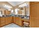 Spacious bathroom with double sinks, granite countertops, and wood cabinetry at 1367 Honea Path, The Villages, FL 32162
