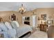 Luxurious bedroom with a beautiful chandelier and neutral color palette at 1367 Honea Path, The Villages, FL 32162