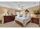 Bright bedroom with a ceiling fan, two dressers, and ample closet space at 1367 Honea Path, The Villages, FL 32162