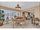 Cozy dining area open to the living room, featuring a round table set for a meal at 1367 Honea Path, The Villages, FL 32162
