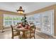Bright dining room featuring a round table and chairs and large windows with plantation shutters at 1367 Honea Path, The Villages, FL 32162
