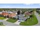 An elevated view of this home shows mature landscaping and a three car garage at 1367 Honea Path, The Villages, FL 32162