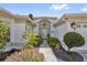 Inviting front entrance with beautiful landscaping and an elegant chandelier at 1367 Honea Path, The Villages, FL 32162