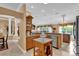 Spacious kitchen with oak cabinets, stone countertops, and stainless steel dishwasher at 1367 Honea Path, The Villages, FL 32162