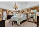 Luxurious main bedroom featuring elegant decor, chandelier, and ample natural light at 1367 Honea Path, The Villages, FL 32162