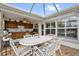Covered patio with outdoor kitchen and dining set, perfect for backyard entertaining at 1367 Honea Path, The Villages, FL 32162