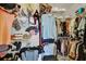Organized walk-in closet showcasing clothing, hats, and accessories at 1367 Honea Path, The Villages, FL 32162