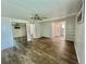 Spacious bedroom featuring wood-look flooring, a ceiling fan, and a sliding-door closet at 137 Hibiscus Way, Leesburg, FL 34748