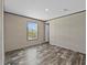 Bedroom with window and wood-look flooring at 147 Woodstork Way, Frostproof, FL 33843